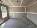 Unfinished room featuring newly installed drywall and trim and a single window providing natural light at 43 Chloe Ct, Selma, NC 27577