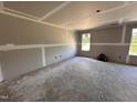 Unfinished room featuring newly installed drywall and trim and two windows providing natural light at 43 Chloe Ct, Selma, NC 27577