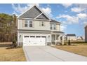 Charming two-story home with a two-car garage and stone accents at 46 Lupin Dr, Smithfield, NC 27577