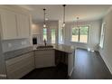 Modern kitchen features granite countertops, stainless sink, and stylish pendant lighting at 47 Royal Ave, Selma, NC 27576