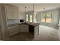 Bright kitchen featuring granite countertops, stainless steel sink, and pendant lighting at 47 Royal Ave, Selma, NC 27576