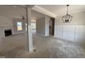Spacious living room with a fireplace, decorative pillars and large windows letting in natural light at 47 Royal Ave, Selma, NC 27576