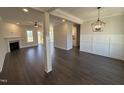 Spacious living room featuring hardwood floors, fireplace, recessed lighting, and decorative wainscoting at 47 Royal Ave, Selma, NC 27576