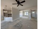 Open-concept layout with modern lighting and a partial view of the kitchen and dining areas at 47 Royal Ave, Selma, NC 27576