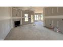 View of the living room with fireplace, awaiting finishing touches at 47 Royal Ave, Selma, NC 27576