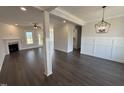 Spacious living room with wood floors, fireplace, and abundant natural light at 47 Royal Ave, Selma, NC 27576