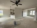 Spacious living area with a ceiling fan, open layout, and access to the kitchen at 47 Royal Ave, Selma, NC 27576