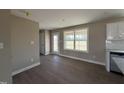 Dining area featuring neutral walls, hardwood floor, and natural light from a window at 48 Silver Ct, Smithfield, NC 27577