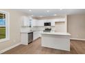 Well-lit kitchen features stainless steel appliances, granite countertops, and island at 48 Silver Ct, Smithfield, NC 27577