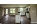 Modern kitchen featuring granite countertops, white cabinets, and stainless steel appliances at 48 Silver Ct, Smithfield, NC 27577