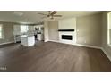 A modern open-concept living room featuring hardwood floors and an electric fireplace at 48 Silver Ct, Smithfield, NC 27577