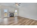 Bright living room with wood floors, fireplace, and ample natural light from the windows at 54 Barony Ln, Smithfield, NC 27577