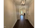 Elegant hallway with dark hardwood floors and modern lighting fixtures at 56 Bailey-Boykin Rd, Selma, NC 27576