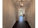 Bright hallway with dark wood floors, light walls, and a decorative light fixture at 56 Bailey-Boykin Rd, Selma, NC 27576