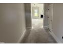 A glimpse into the bright, open-concept home featuring a fireplace, large windows, and freshly painted walls at 56 Bailey-Boykin Rd, Selma, NC 27576