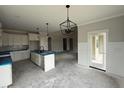 Modern kitchen featuring center island with seating, white cabinetry, and sleek pendant lighting at 56 Bailey-Boykin Rd, Selma, NC 27576