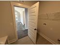 Well-lit laundry room with tile floors at 56 Bailey-Boykin Rd, Selma, NC 27576