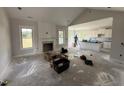Spacious living room and kitchen area with white cabinetry and modern finishes under construction at 56 Bailey-Boykin Rd, Selma, NC 27576