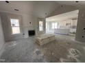 Bright living room with fireplace, two windows, open floor plan, and doors ready for install at 56 Bailey-Boykin Rd, Selma, NC 27576