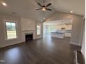 Spacious living room with fireplace seamlessly flows into kitchen and dining area at 56 Bailey-Boykin Rd, Selma, NC 27576
