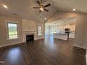 Open-concept living area with fireplace, hardwood floors, and abundant natural light at 56 Bailey-Boykin Rd, Selma, NC 27576