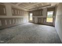 Spacious main bedroom with ample natural light from large windows ready for finishing touches at 56 Bailey-Boykin Rd, Selma, NC 27576