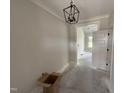Unfurnished room with a modern black chandelier and view to another bright room at 56 Bailey-Boykin Rd, Selma, NC 27576