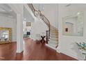 Grand foyer with hardwood floors, staircase, and elegant chandelier showcasing the architectural design at 5928 Terrington Ln, Raleigh, NC 27606