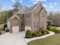 Aerial view of a brick two-story house with attached two-car garage and well-manicured lawn at 5928 Terrington Ln, Raleigh, NC 27606