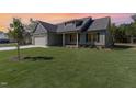 Inviting single-Gathering home features a well-maintained lawn and covered porch, bathed in a sunset glow at 609 Tuscany Cir, Princeton, NC 27569