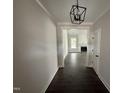 View of a hallway with modern lighting and a glimpse into the living room at 612 Tuscany Cir, Princeton, NC 27569