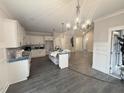 Bright, modern kitchen with stainless appliances, center island, and stylish pendant lighting at 612 Tuscany Cir, Princeton, NC 27569