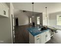 Bright kitchen with an island and an open view to the living room at 612 Tuscany Cir, Princeton, NC 27569