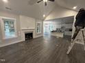 Spacious living room with hardwood floors, fireplace, and open layout to kitchen at 612 Tuscany Cir, Princeton, NC 27569