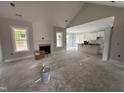 Bright living room with fireplace and large windows, seamlessly connecting to the modern kitchen and dining areas at 612 Tuscany Cir, Princeton, NC 27569