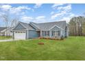 Stylish home with a well-manicured lawn, featuring a two-car garage and beautiful landscaping at 613 Tuscany Cir, Princeton, NC 27569