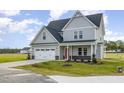Charming two-story home with a two-car garage, complemented by a well-manicured lawn at 65 Barony Ln, Smithfield, NC 27577