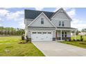 Charming two-story home with a two-car garage, complemented by a well-manicured lawn at 65 Barony Ln, Smithfield, NC 27577
