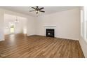 A well-lit living room with a fireplace and wood-look floors at 65 Barony Ln, Smithfield, NC 27577