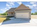Well-designed home with a two-car garage, complemented by a beautifully landscaped yard and inviting facade at 68 Tee Dr, Selma, NC 27576