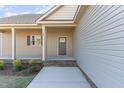 Inviting front porch with classic columns, brick accents, and a well-maintained lawn, offering curb appeal at 68 Tee Dr, Selma, NC 27576