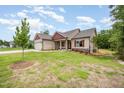 Attractive home with well-maintained lawn and landscaping; a tree is planted in the front yard at 702 Tuscany Cir, Princeton, NC 27569