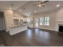Kitchen and living room featuring granite counters, pendant lights, and an open concept at 702 Tuscany Cir, Princeton, NC 27569