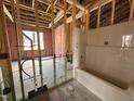 Unfinished bathroom with insulated walls and a new, installed bathtub with waterlines at 71 Royal Ave, Selma, NC 27576