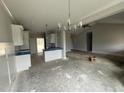 Open-concept kitchen features white cabinets, modern lighting, and connection to the living area at 71 Royal Ave, Selma, NC 27576