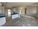 Open floor plan with kitchen island and views of living room, great for entertaining at 71 Royal Ave, Selma, NC 27576