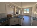 Bright kitchen with granite countertops and an open design to the living areas at 71 Royal Ave, Selma, NC 27576