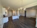 Bright kitchen boasts white cabinets, granite countertops, stainless appliances and island seating at 71 Royal Ave, Selma, NC 27576