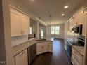 Modern kitchen features granite countertops, stainless steel appliances, and dark wood flooring at 71 Royal Ave, Selma, NC 27576