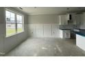 Bright living room featuring decorative wall trim, a large window, and an easy transition to the kitchen at 71 Royal Ave, Selma, NC 27576